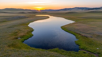 Fototapeta premium Serene Sunset Over Grassland River Scenic Nature Photography