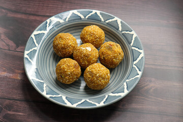 Gond and methi ke laddoo. Sweet Dink laddu also known as Dinkache ladu in Marathi. Recipe ingedients such as fry fruits, Fenugreek seeds, Khaskhas, Edible gum, Garden Cress Seeds, sugar. copy space.