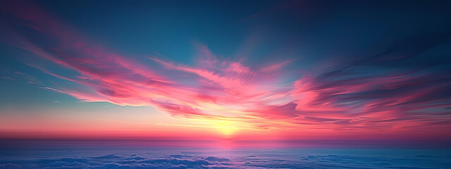 A breathtaking sunset paints the sky in vibrant hues of pink and orange, casting a serene glow over soft, fluffy clouds.