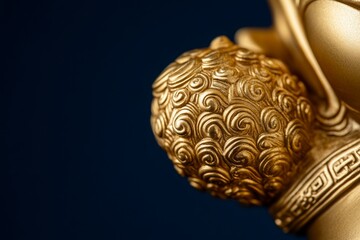 Fototapeta premium Close-up of golden decorative sculpture with intricate swirling patterns