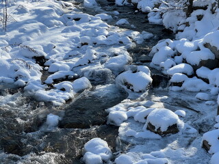 A river in a mountainous area in winter. A stormy stream.