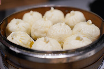 Steamed xiao long bao in bamboo steaming bowl. Chinese steamed bun. Dim sum. Chinese food