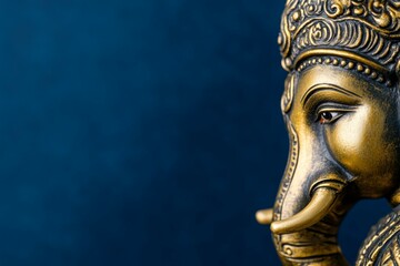 Obraz premium Golden ganesha statue with intricate elephant design on blue background