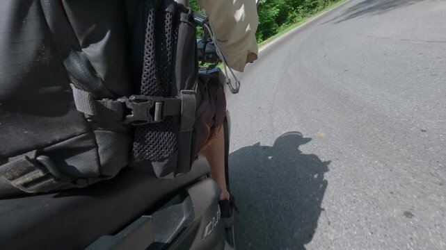 Action camera mounted low near the pillion seat, capturing the RHS of a scooter as it turns right and rides on the road in Thailand.