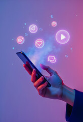 Hand holding smartphone with glowing social media icons
