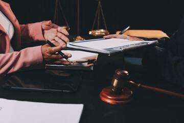 Judge gavel with Justice lawyers having team meeting at law firm background. Concepts of Law and...