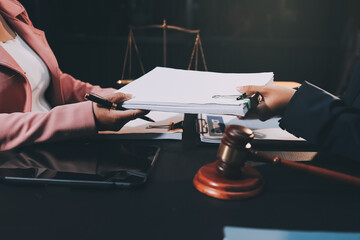 Judge gavel with Justice lawyers having team meeting at law firm background. Concepts of Law and...