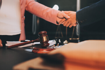 Judge gavel with Justice lawyers having team meeting at law firm background. Concepts of Law and...