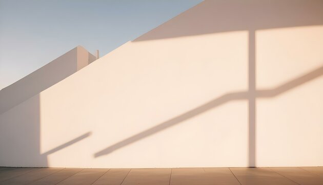 Una pared blanca y lisa con una sombra diagonal que la atraviesa, creando una composici&oacute;n simple y minimalista