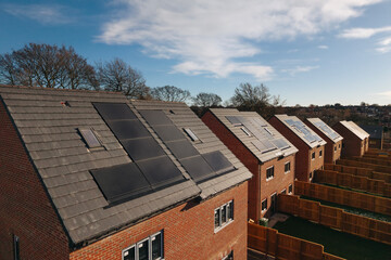 Aerial view from drone at Solar panels harnessing sunlight on modern homes in a suburban...