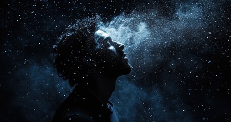 Obraz premium Ethereal Portrait of a Man Surrounded by Cosmic Dust and Stars, Evoking a Sense of Wonder and Infinity Against a Dark Background