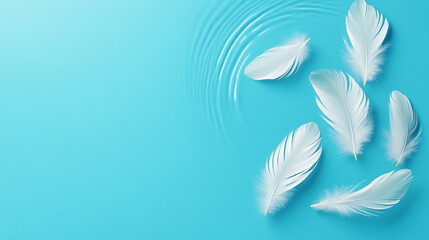 Naklejka premium Delicate white feathers floating on tranquil blue water, creating a serene ambiance.