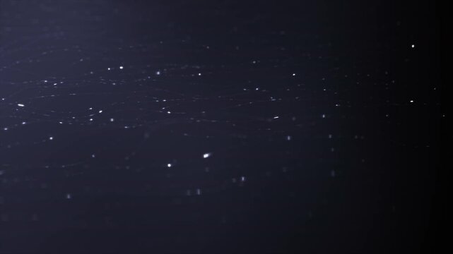 Abstract background animation with white particles floating and glowing on a black background. The particles move in a random and organic pattern