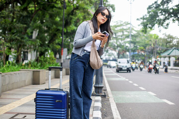 Asian Tourist Woman Looking For a Taxi on City Street