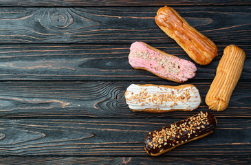 Assorted eclairs on a pastel top view Traditional French dessert