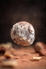 Cocoa balls, chocolate truffle candies with nuts. Flying candies