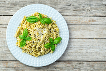 Pasta with basil sauce pesto . Italian food photography . Top view