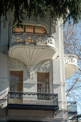 Gypsum balcony of unusual shape on the facade of the house