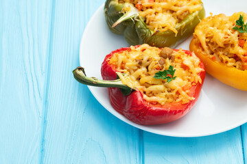 Baked stuffed pepper ( paprika ) with rice , carrot and meat . Top view on rustic background