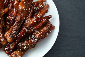 Caramelized korean or Chinese chicken foots ( paws ) with sesame . Top view