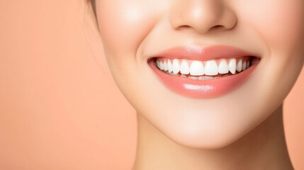 Fototapeta premium close up of Asian woman with bright smile, showcasing her healthy teeth and radiant skin against soft peach background. Her joyful expression conveys warmth and positivity