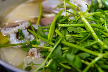 boiling seafood stew with octopus and vegetables