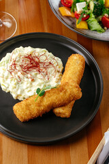 fish nuggets with side dish on a plate