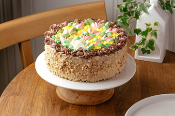 a whole sponge cake with cream flowers