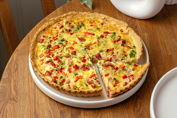 tomato and meat pie on a white plate