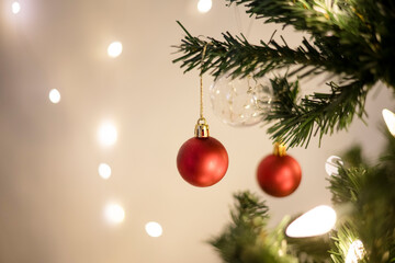 Close up of red ornaments hanging on a christmas tree