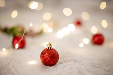 Red ornaments and blurred twinkle lights
