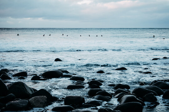 Surfers on the Horizon at Unstad Beach Lofoten