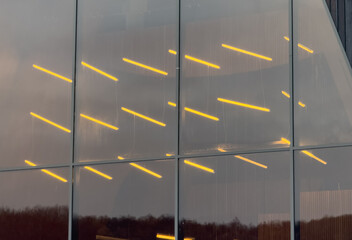 A building with a large window that is reflecting the lights of the street below