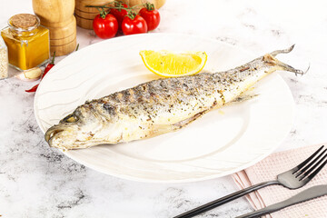 Grilled sea bass fish served lemon