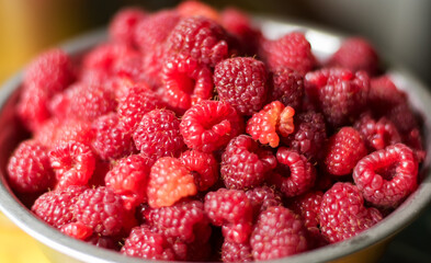 Close-up of raspberries in a bowl. Background with raspberries.