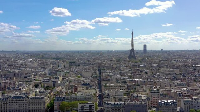PARIS, FRANCE - OCTOBER 3, 2024: Stunning aerial view of Paris skyline showcasing the Eiffel Tower and vibrant cityscape under clear blue sky