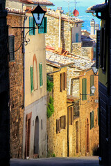 Fototapeta premium Narrow street in historic center of Montalcino town, Val d'Orcia, Tuscany, Italy