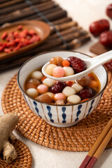 Homemade red and white tangyuan with syrup soup, dried longan pulp, red dates for Winter solstice.