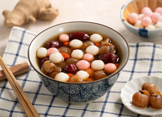 Homemade red and white tangyuan with syrup soup, dried longan pulp, red dates for Winter solstice.