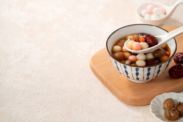 Homemade red and white tangyuan with syrup soup, dried longan pulp, red dates for Winter solstice.