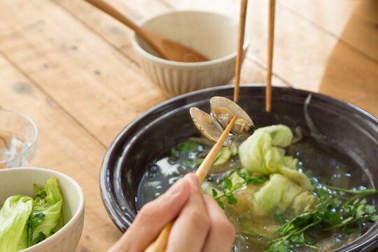 Eating Japanese-style one-pot dish of asari clam and Japanese parsley