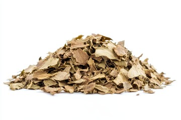 Dried herb leaves piled on a white surface, showcasing natural texture and color variations