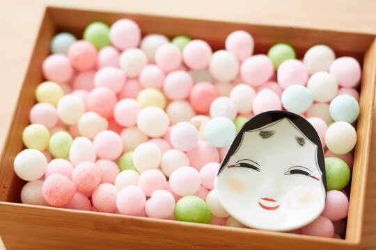 Arare and okame in a bowl on a wooden top board