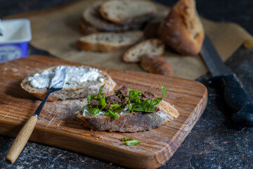 sliced bread on cutting board, ready to make open-faced sandwich