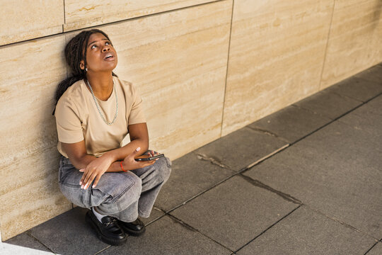 Young African American frustrated and upset outdoors urban building