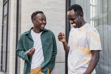 Two African American men talking, smiling and laughing