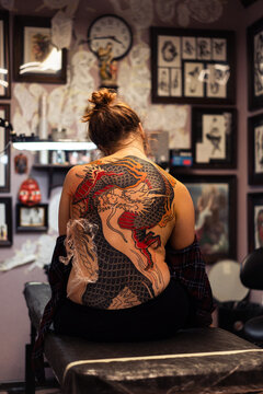 Traditional Japanese dragon tattoo in progress on a woman's back