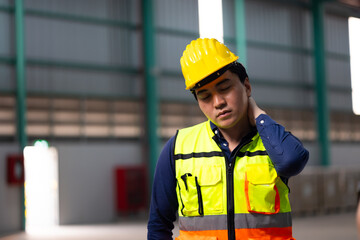 Tired hot wiping sweat. Asian man Warehouse staff Employees worker standing by goods shelf working in large warehouse. transport and storage of goods. supply chain and delivery