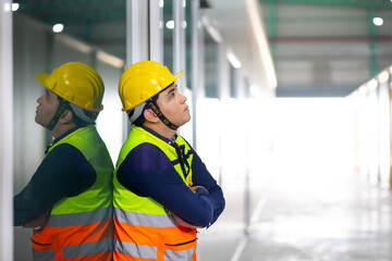 Tired hot wiping sweat. Asian man Warehouse staff Employees worker standing by goods shelf working in large warehouse. transport and storage of goods. supply chain and delivery