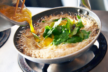 Photograph of the process of making tamagodon